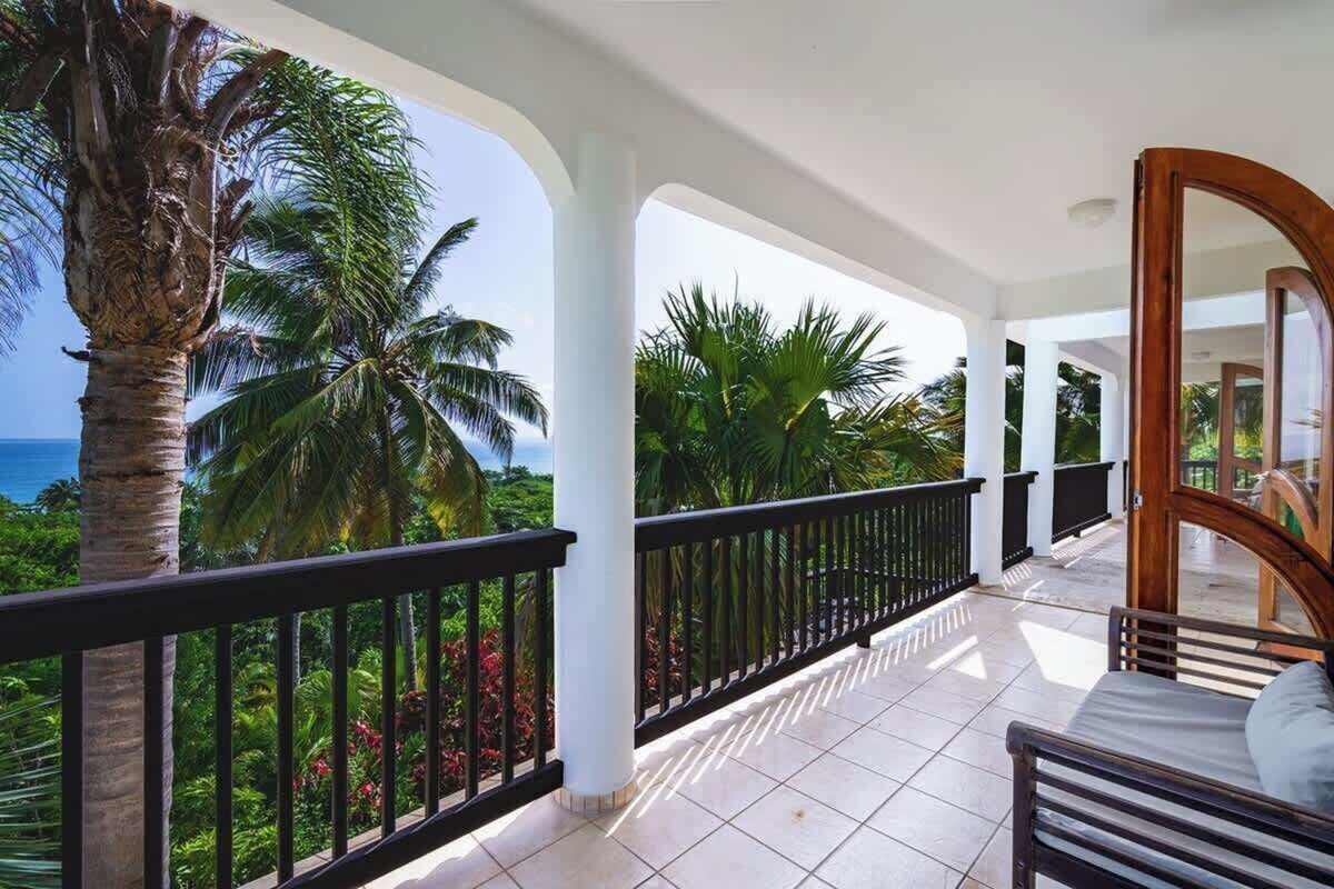 Balcony sitting nook framed by palm fronds