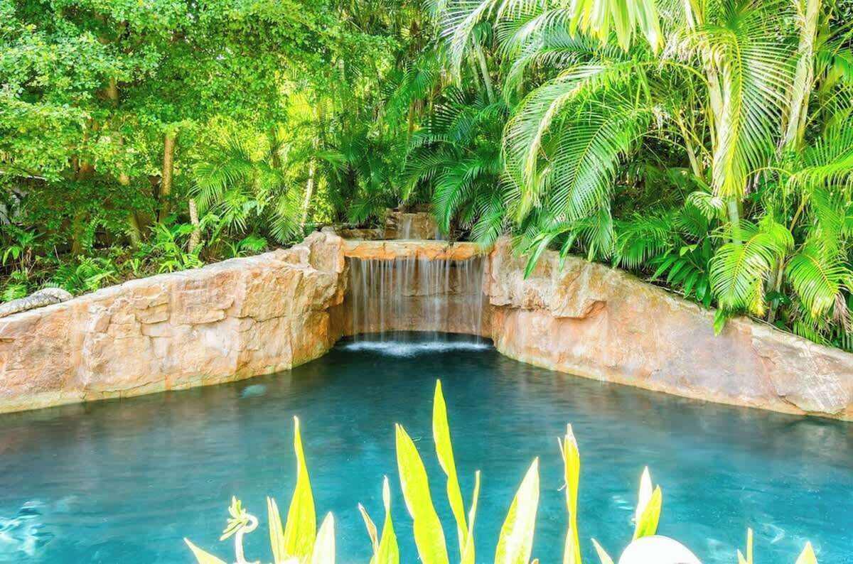 Stone grotto waterfall spilling into the pool