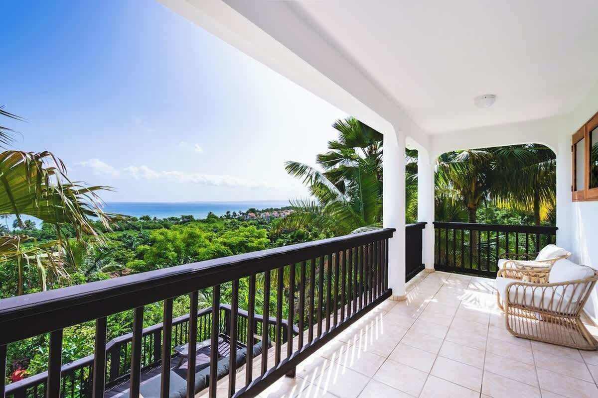 Covered veranda with daybed and railing at golden hour